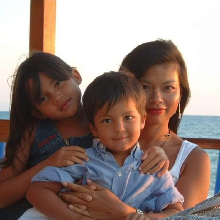 Genevieve Cheung with her two children by the sea, a family portrait reflecting motherhood, care, and shared presence.